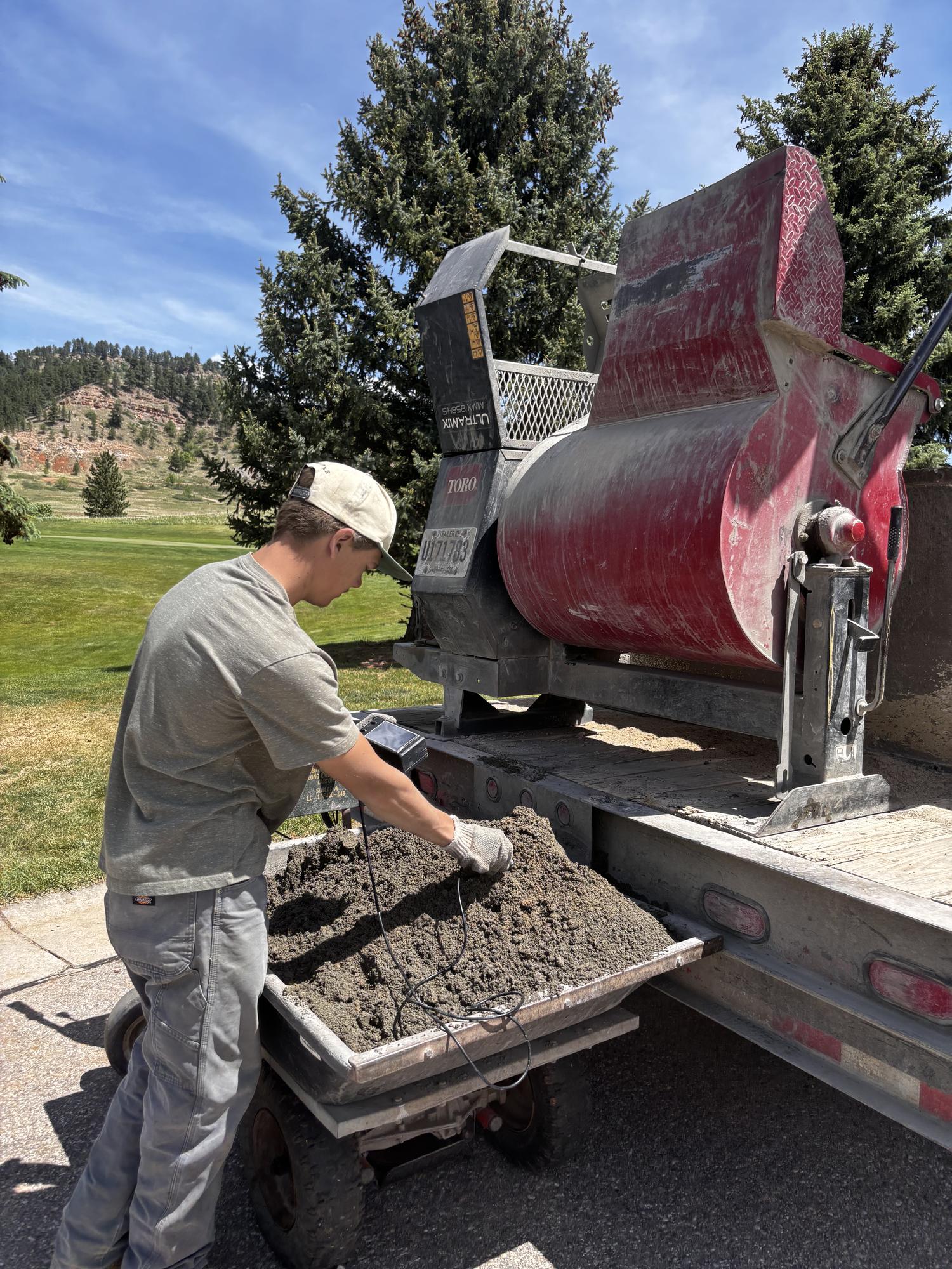 Crew member probing a fresh concrete mix with the SlumpMeter sensor